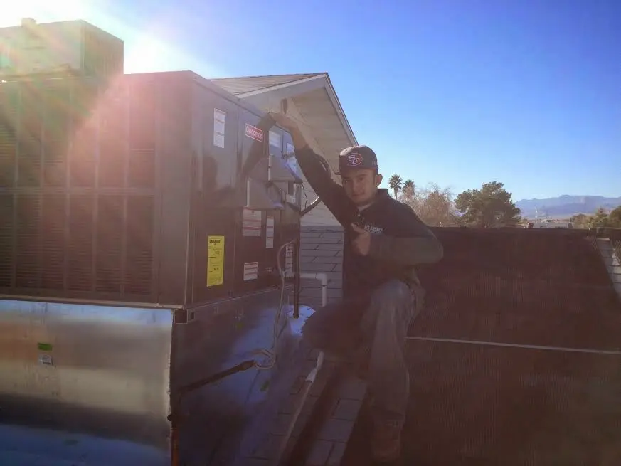 HVAC technician performing AC Tune-Up on a rooftop unit in East Hempfield